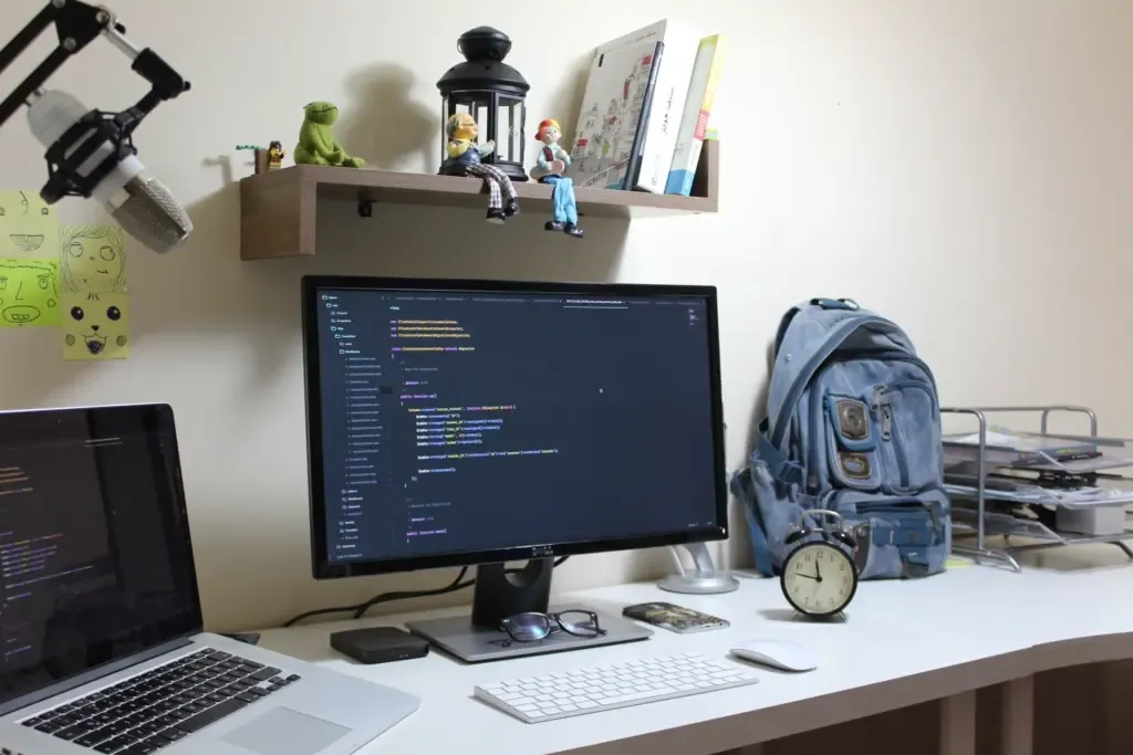 A workplace setup, with a computer and laptop to make sure all the work can be completed
